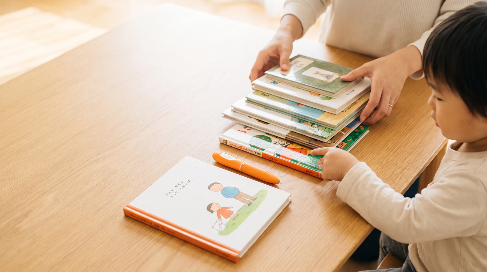 What is the difference between a talking picture book and an ordinary picture book in terms of long-term cost?