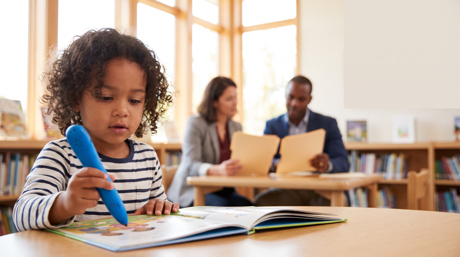 Child using an unbranded reading pen and book materials for Reading Pen Public Sector Procurement