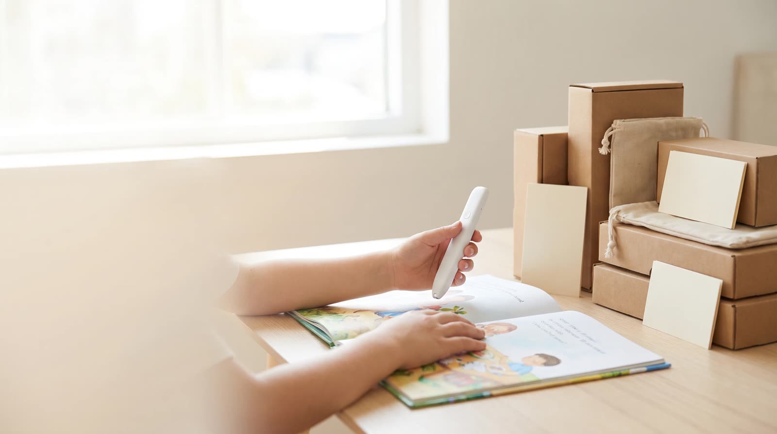 Child using an unbranded reading pen with an interactive learning book during first-order commercial planning