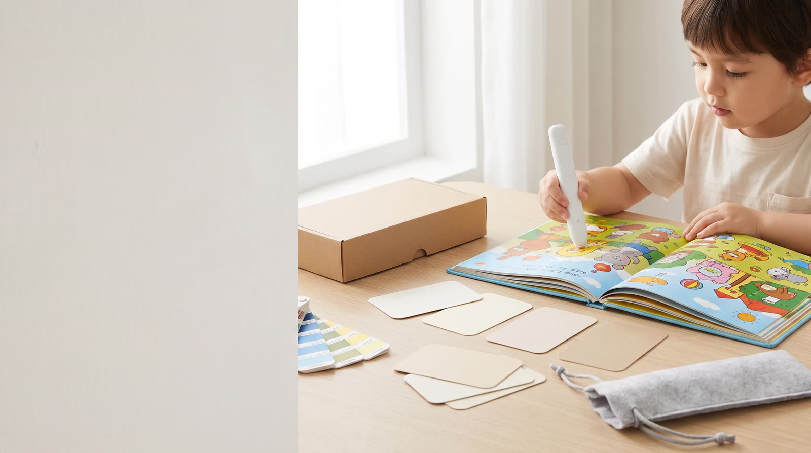 Child using an unbranded reading pen with an interactive learning book during custom-branded product development