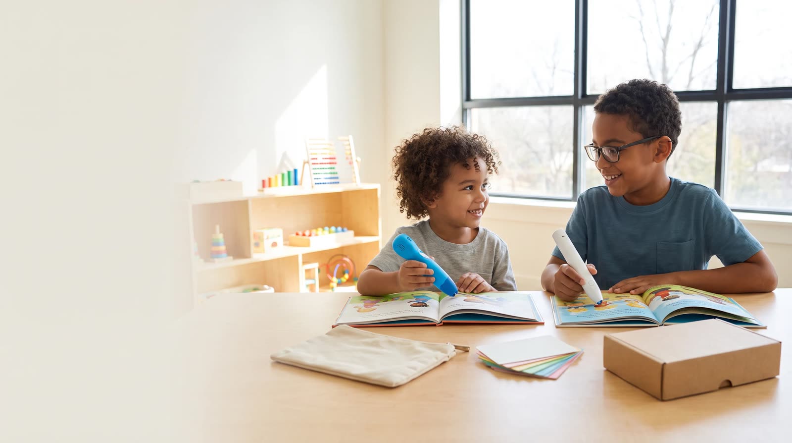 Child using an unbranded reading pen with an interactive learning book during market-led product design